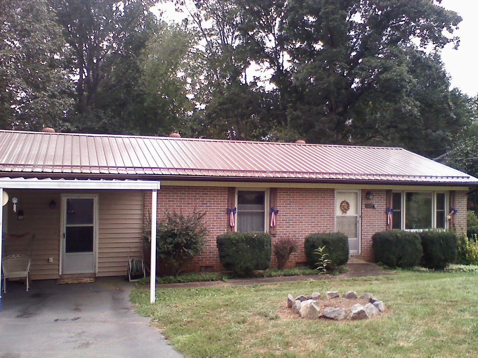 Bronze metal roof and carport on a brick ranch home — Roof Repair work by our crew in South Hackensack